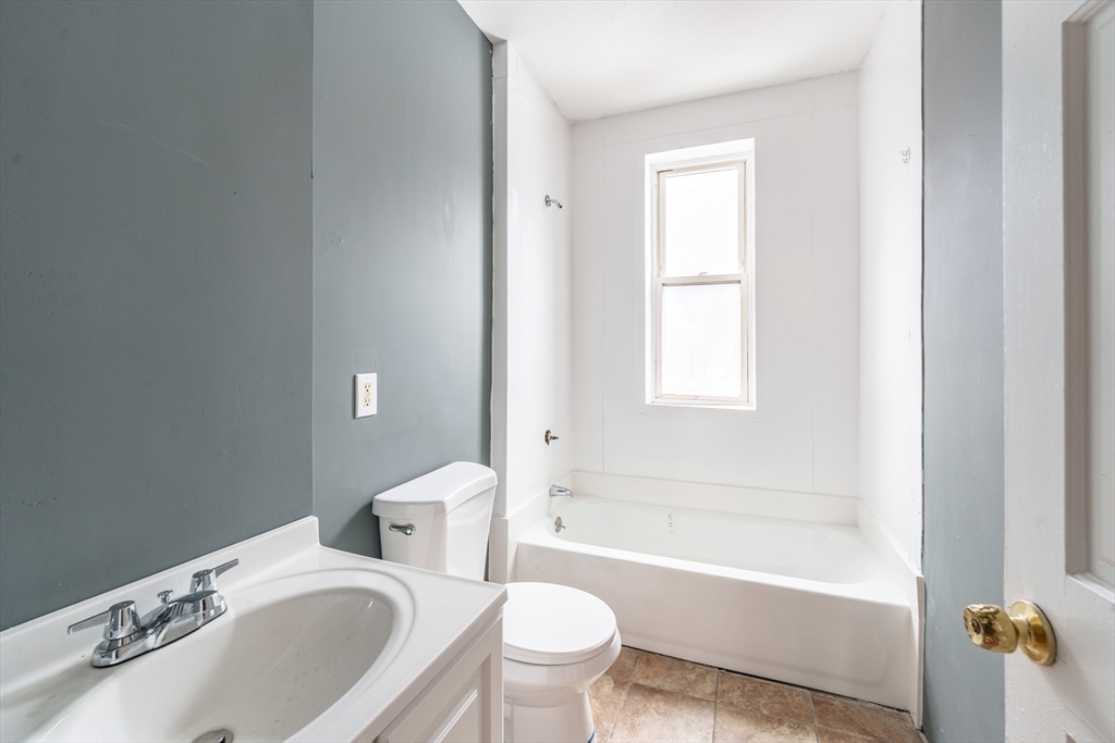 173 Elm Street, Unit 3LR Holyoke, MA 01040 - Photo 5 of 5 a bathroom with a sink toilet and bathtub
