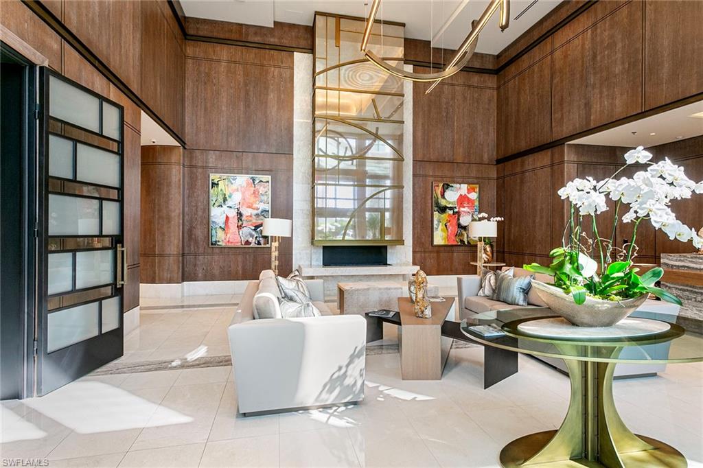 6897 Grenadier Boulevard, Unit 207 Naples, FL 34108 - Photo 14 of 27 a living room with couches a table and chairs