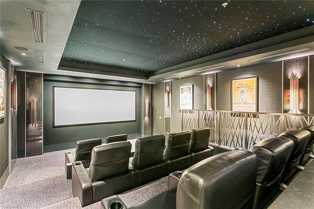6897 Grenadier Boulevard, Unit 207 Naples, FL 34108 - Photo 15 of 27 a media room with lots of chairs and a projector screen