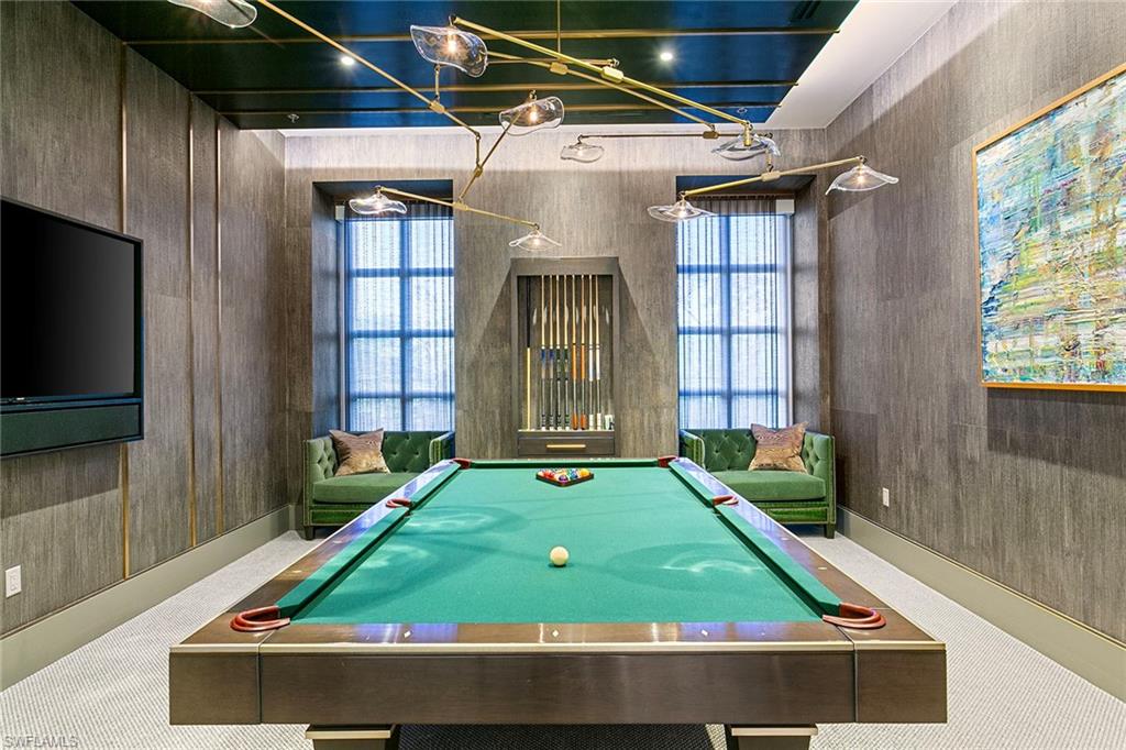 6897 Grenadier Boulevard, Unit 207 Naples, FL 34108 - Photo 17 of 27 a room with furniture and a flat screen tv