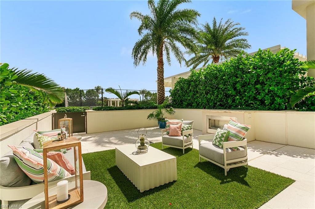 6897 Grenadier Boulevard, Unit 207 Naples, FL 34108 - Photo 18 of 27 a view of a patio with couches potted plants and water view