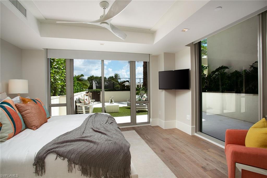6897 Grenadier Boulevard, Unit 207 Naples, FL 34108 - Photo 25 of 27 a bedroom with a bed and glass window