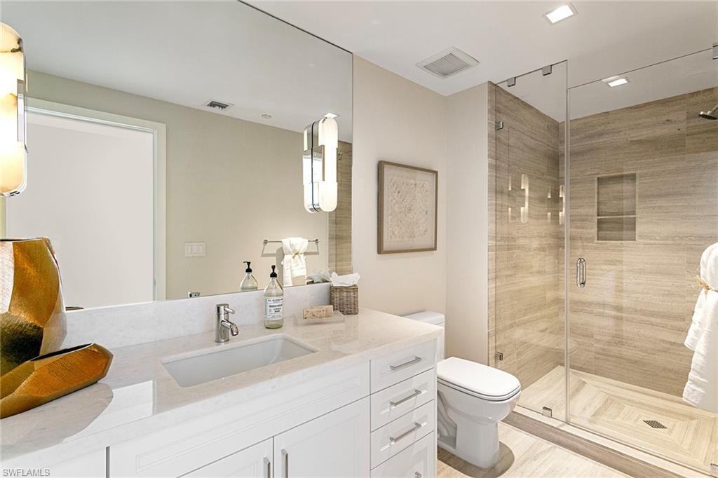 6897 Grenadier Boulevard, Unit 207 Naples, FL 34108 - Photo 26 of 27 a bathroom with a toilet sink and shower