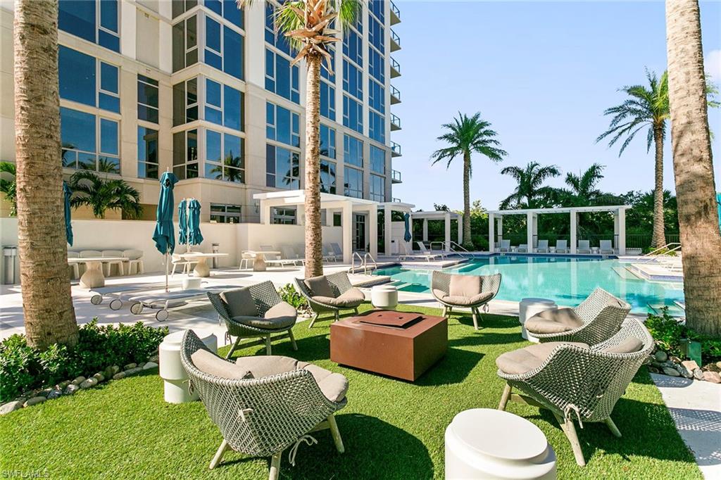 6897 Grenadier Boulevard, Unit 207 Naples, FL 34108 - Photo 5 of 27 a front view of a house with swimming pool and patio