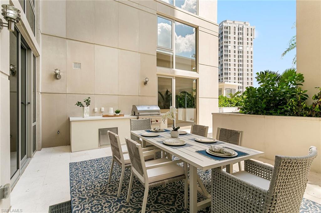 6897 Grenadier Boulevard, Unit 207 Naples, FL 34108 - Photo 7 of 27 a view of a patio with table and chairs