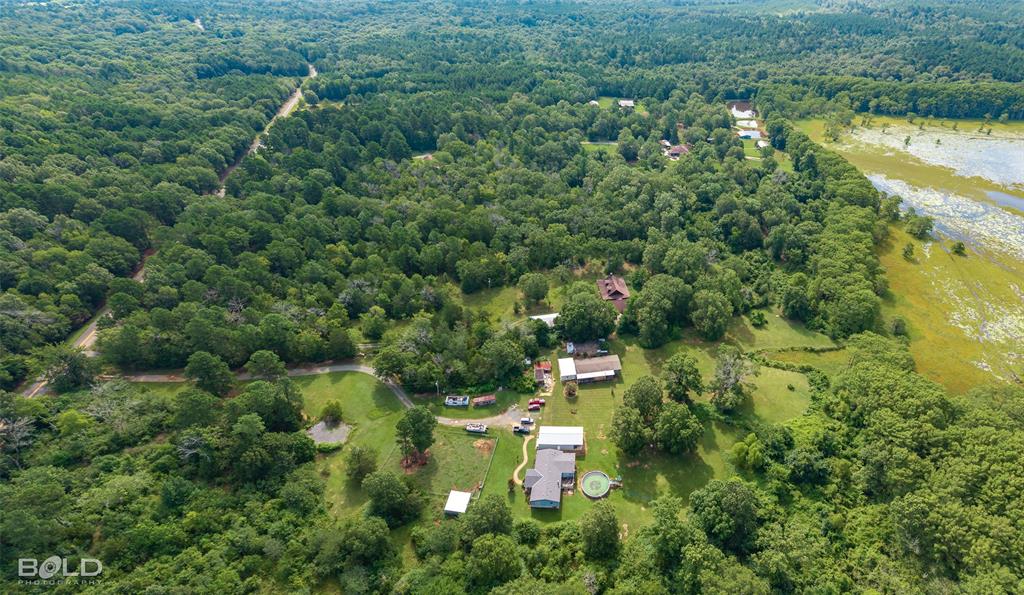 11015 Hereford Road Mooringsport, LA 71060 - Photo 13 of 18 Extensive wooded acreage featuring multiple structures, open clearings, and a substantial waterfrontage