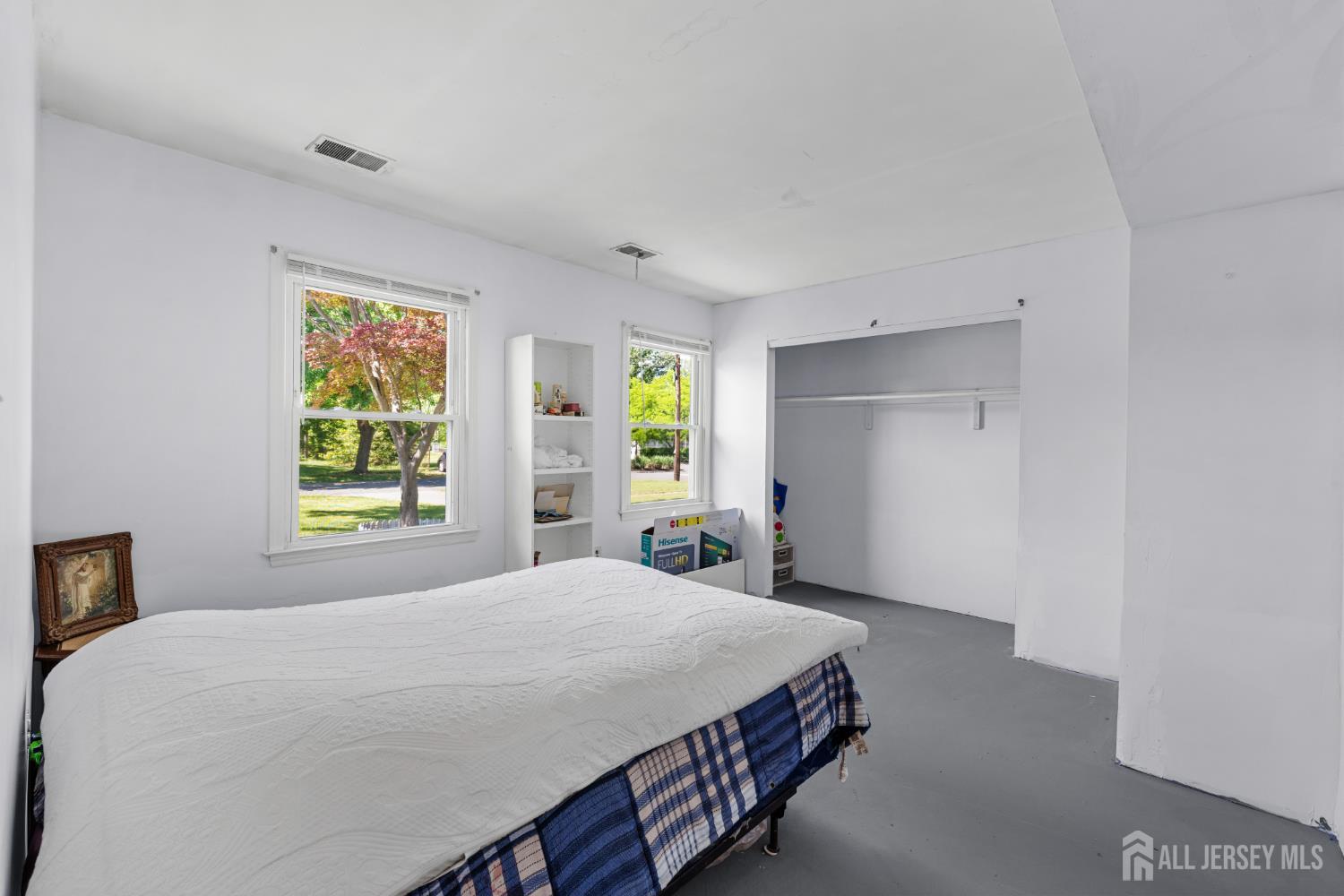 245 4th Street Dunellen, NJ 08812 - Photo 16 of 27 a bedroom with a bed window and mirror