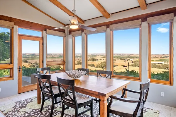a living room with large window and a table
