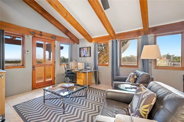 a bedroom with a bed a chandelier and a dresser