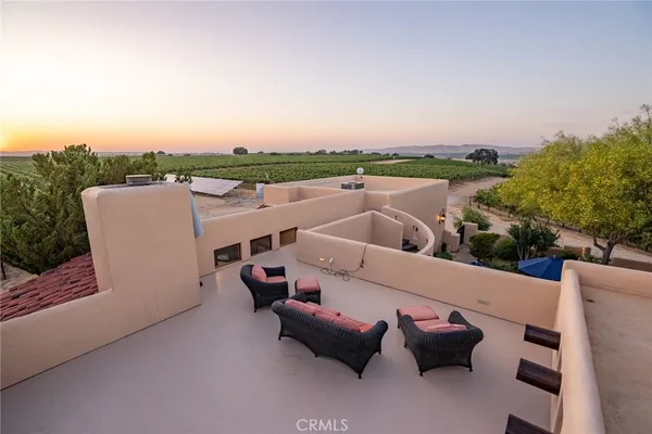 a view of a house with a tree in front