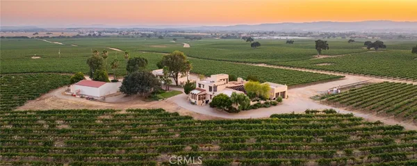 a view of a patio with dining table and chairs