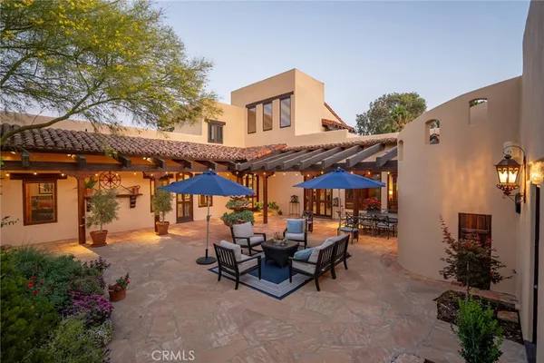 a view of a dining room with furniture a chandelier and wooden floor