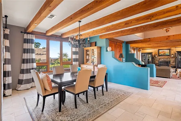 a kitchen with a table chairs sink and cabinets