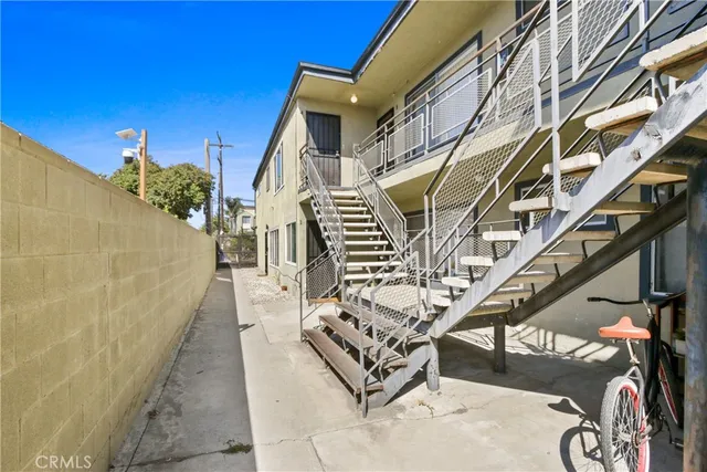 a view of a patio with chairs and potted plants