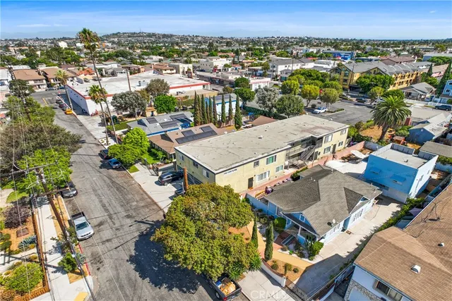 an aerial view of a residential houses with city view