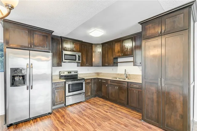 a view of a kitchen with a stove cabinets and wooden floor