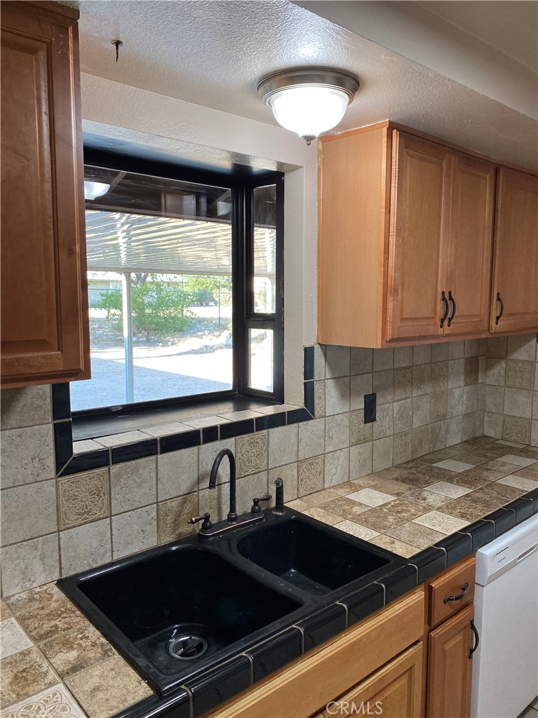 18746 Rock Springs Road Hesperia, CA 92345 - Photo 6 of 21 a kitchen with a sink a stove and cabinets