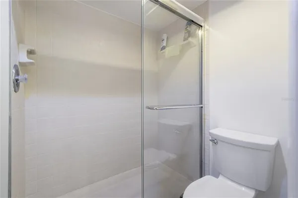 a bathroom with a toilet and a shower