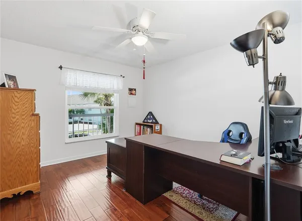 a view of a workspace with furniture and a window