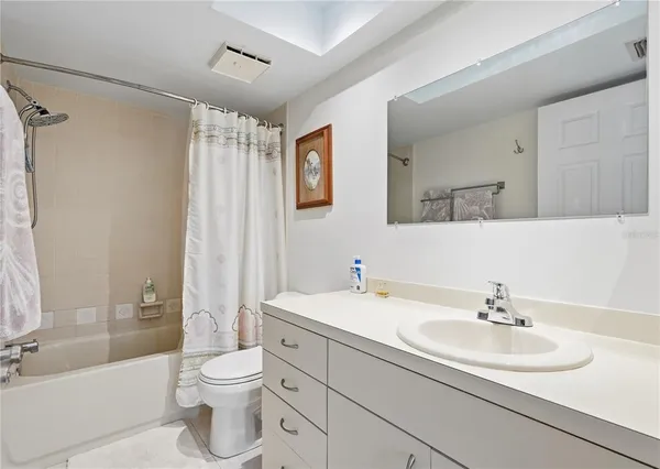 a bathroom with a sink toilet a shower and a mirror