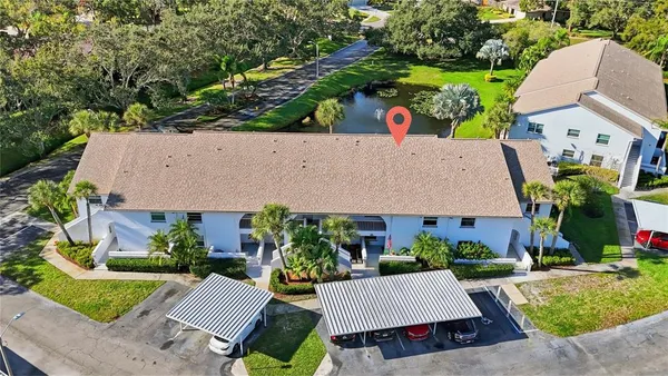 an aerial view of a house with garden space and street view