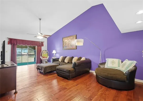 a living room with furniture window and wooden floor