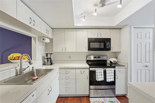 a kitchen with stainless steel appliances granite countertop a sink and a stove