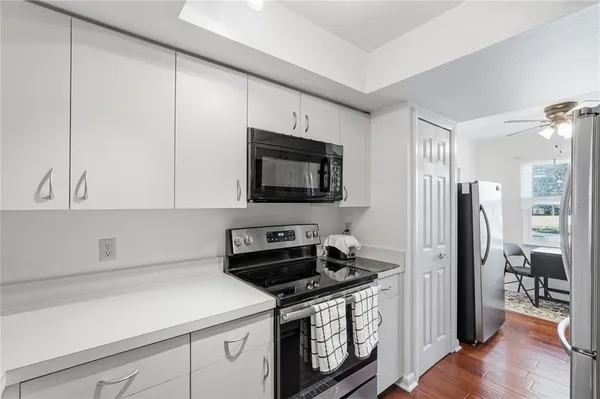 a kitchen with stainless steel appliances a stove microwave and refrigerator