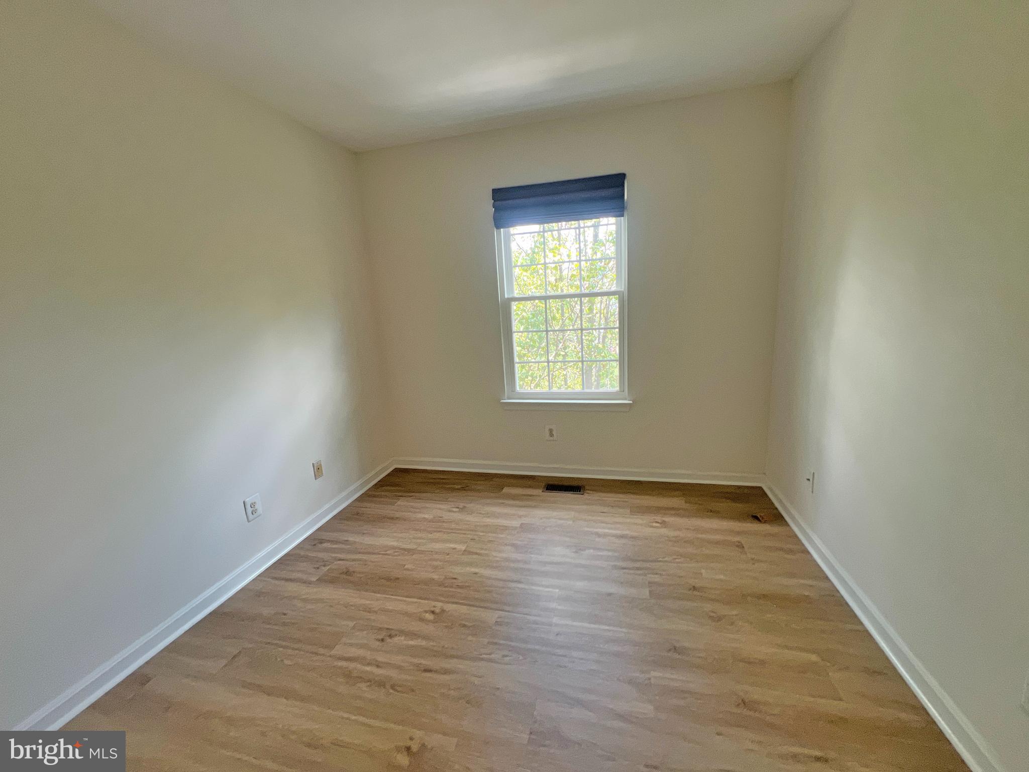 1191 Cypress Tree Place Herndon, VA 20170 - Photo 11 of 18 an empty room with wooden floor and windows