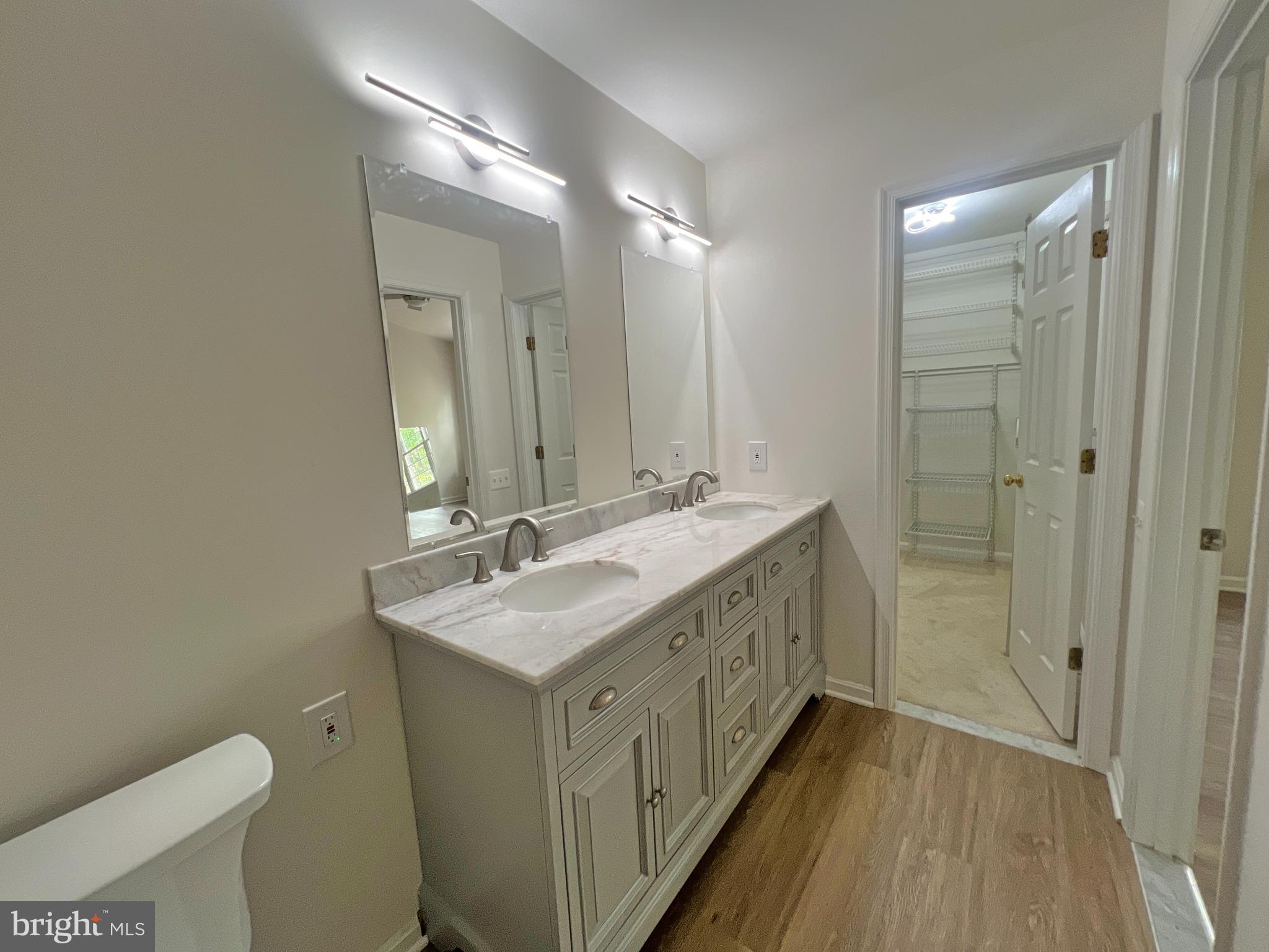 1191 Cypress Tree Place Herndon, VA 20170 - Photo 13 of 18 a bathroom with a double vanity sink toilet and shower