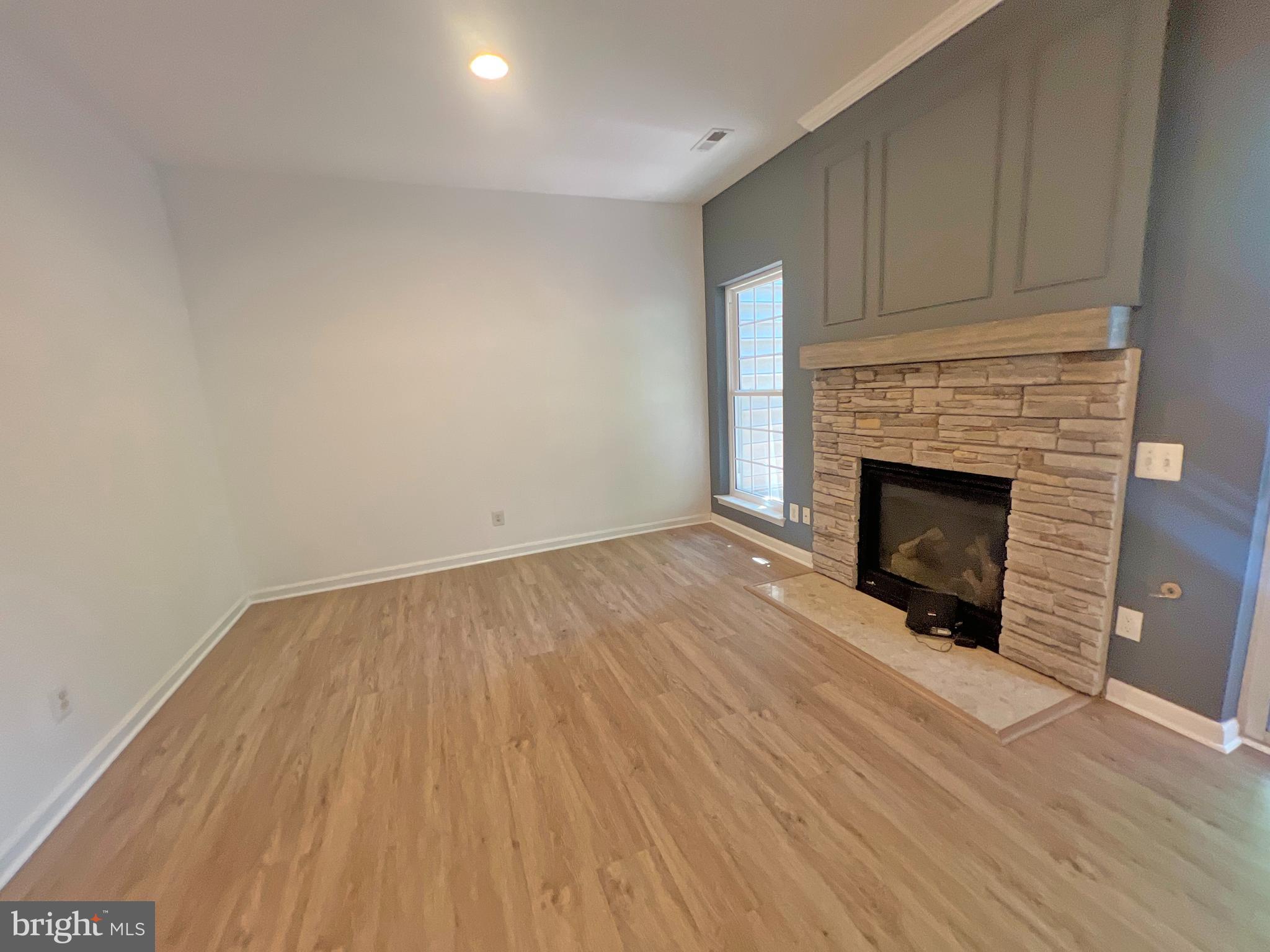 1191 Cypress Tree Place Herndon, VA 20170 - Photo 5 of 18 a view of empty room with wooden floor and fireplace