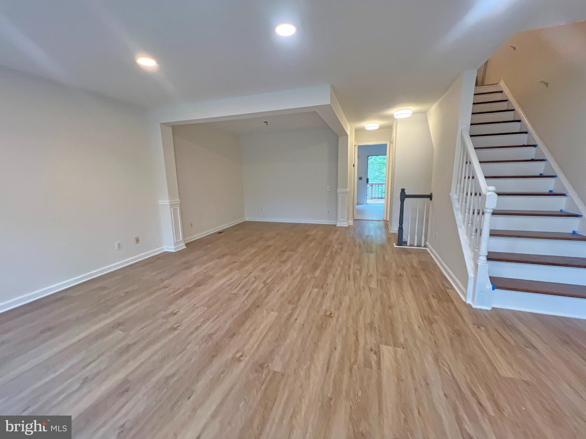 1191 Cypress Tree Place Herndon, VA 20170 - Photo 6 of 18 a view of a room with wooden floor and stairs