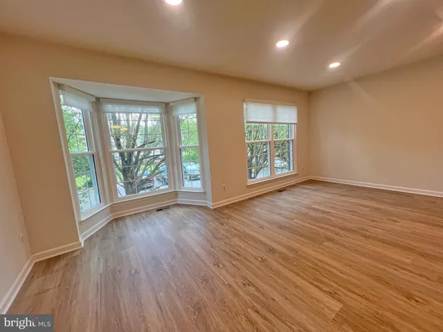 a view of a balcony with wooden floor and fence