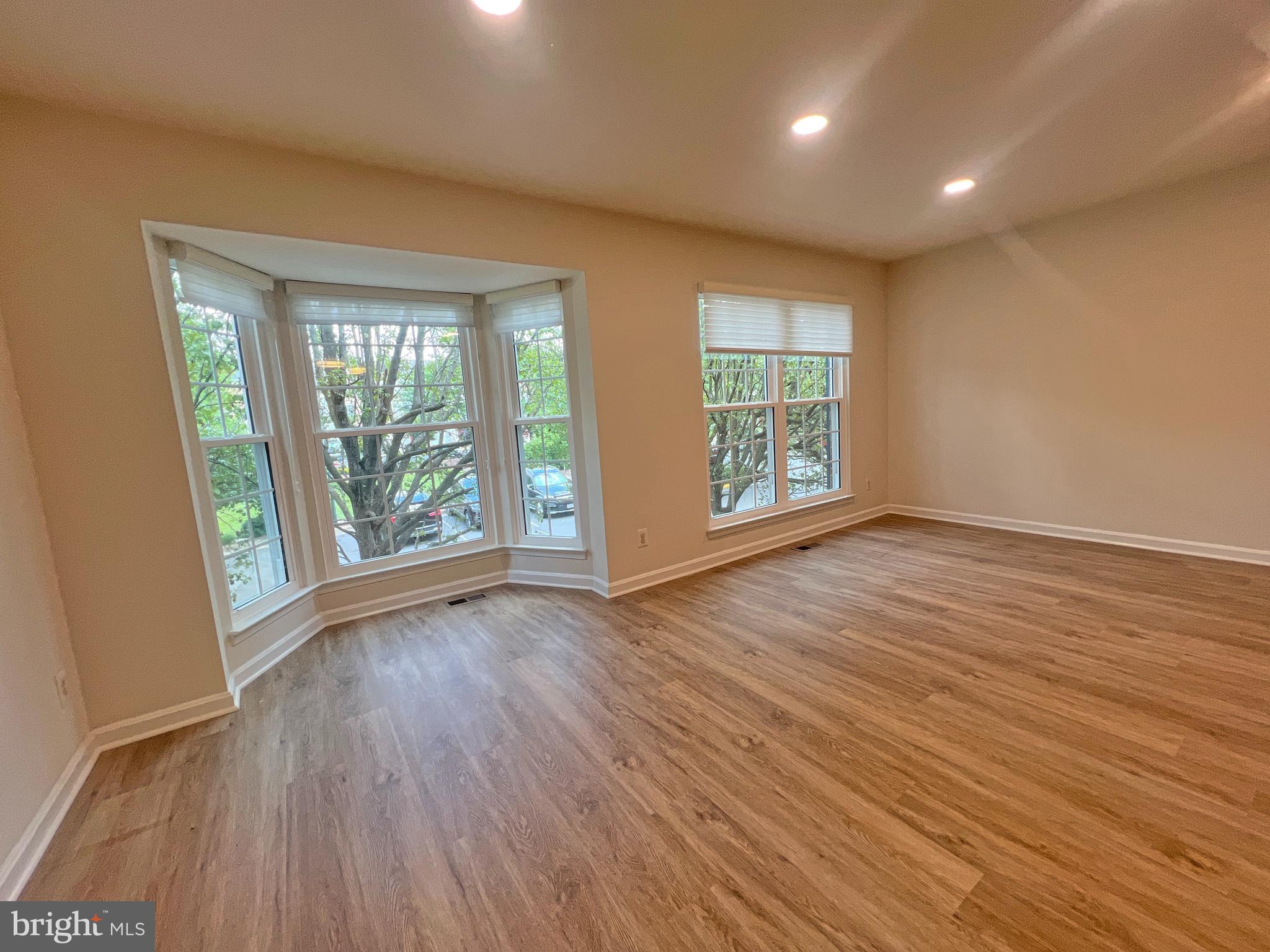 1191 Cypress Tree Place Herndon, VA 20170 - Photo 18 of 18 an empty room with wooden floor and windows