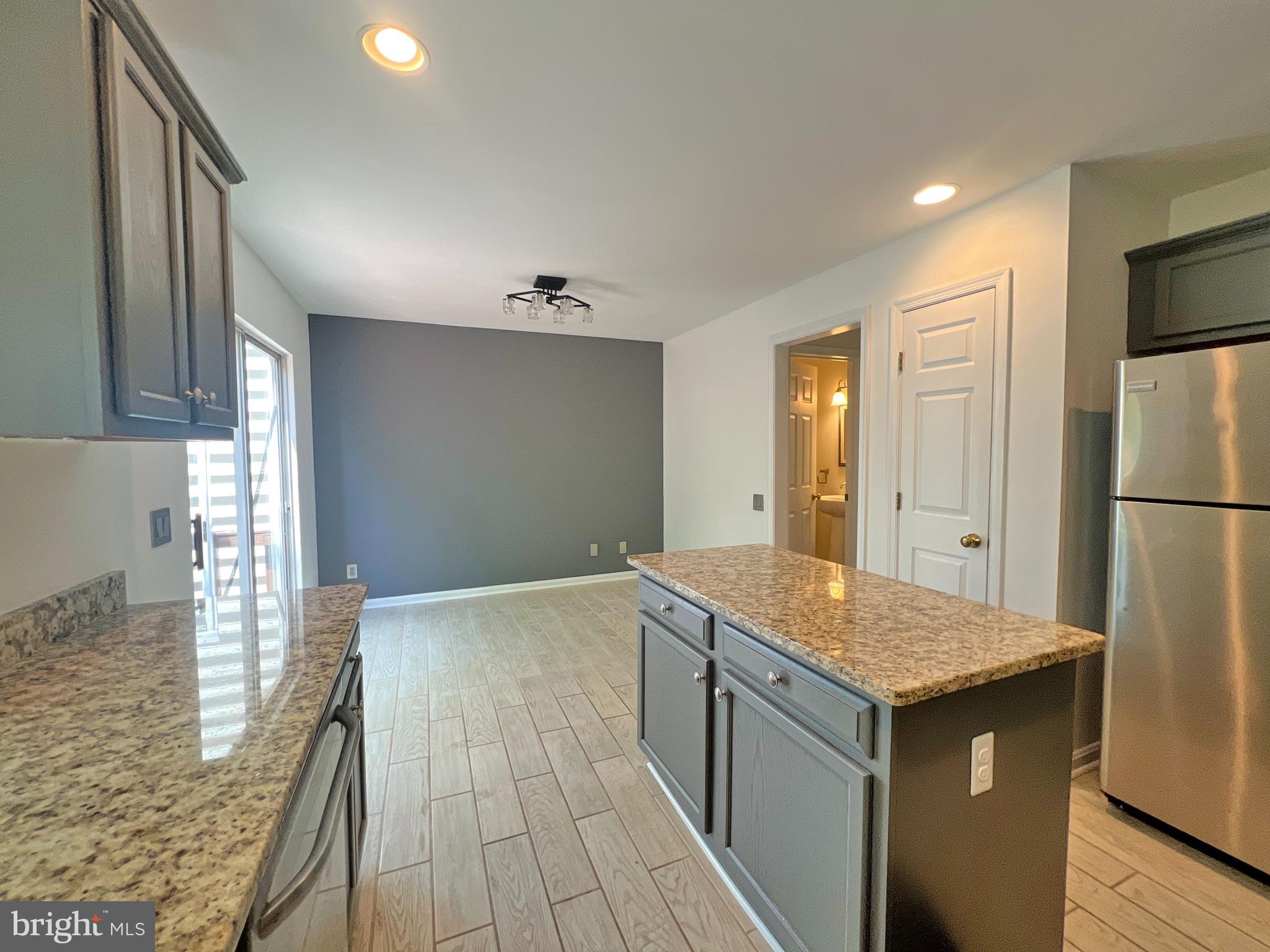 1191 Cypress Tree Place Herndon, VA 20170 - Photo 8 of 18 a kitchen with a sink refrigerator and microwave