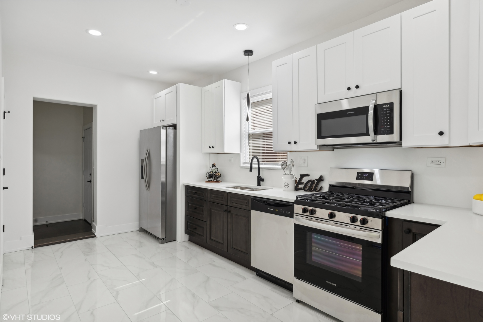 7501 South Morgan Street Chicago, IL 60620 - Photo 9 of 24 a kitchen with stainless steel appliances granite countertop a stove a refrigerator and a microwave