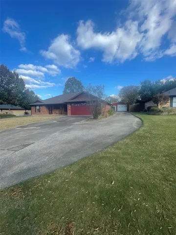 a view of dirt road with large trees