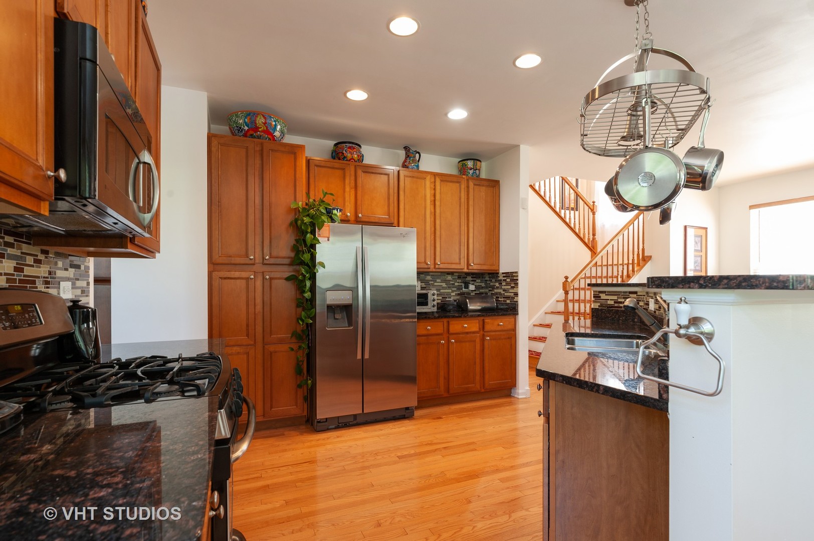 3148 Concord Lane Wadsworth, IL 60083 - Photo 6 of 19 a kitchen with stainless steel appliances granite countertop a stove refrigerator and cabinets