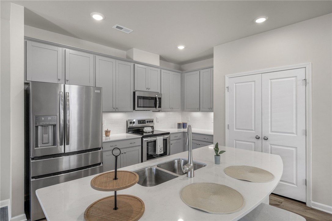 432 Bee Cv Way Pendleton, SC 29670 - Photo 10 of 39 Bright and inviting, this kitchen boasts modern appliances and a functional island with integrated sink.