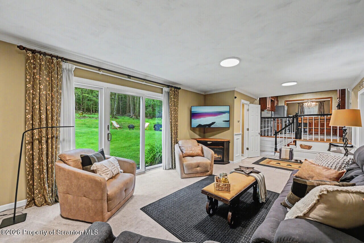 121 T Rt 351 Moscow, PA 18444 - Photo 40 of 79 a living room with furniture and a floor to ceiling window