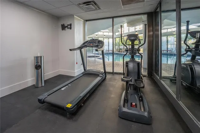 a room with gym equipment and a large window