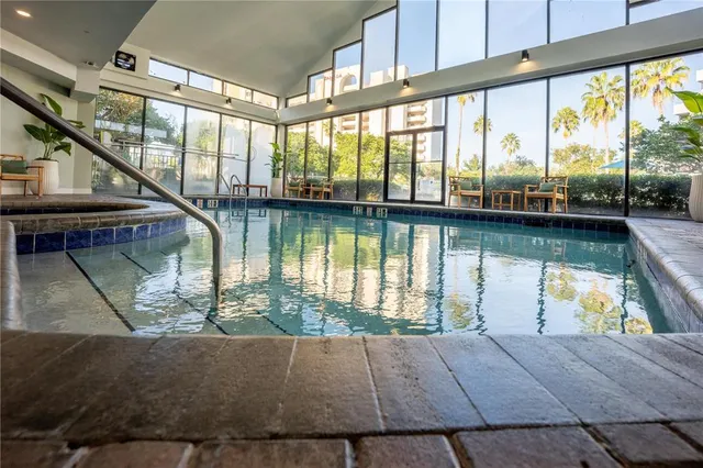 a view of a swimming pool with outdoor seating