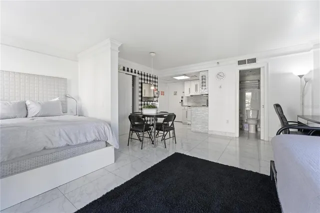 a bedroom with a bed furniture and a large window