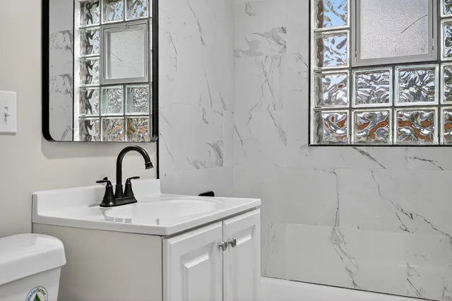 a bathroom with a sink and mirror