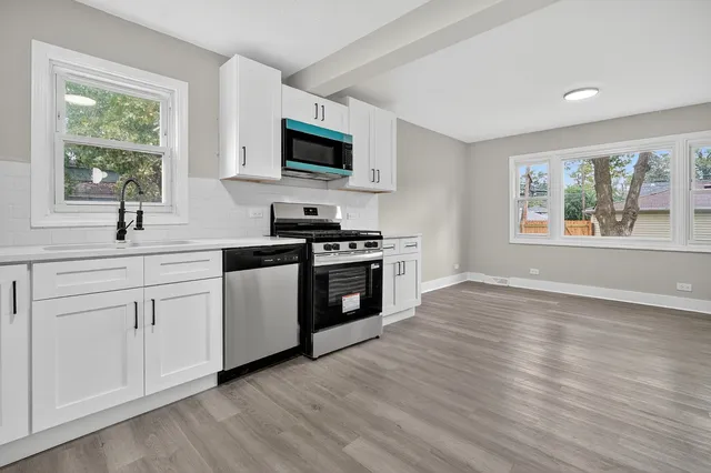 a kitchen with wooden floors and white appliances