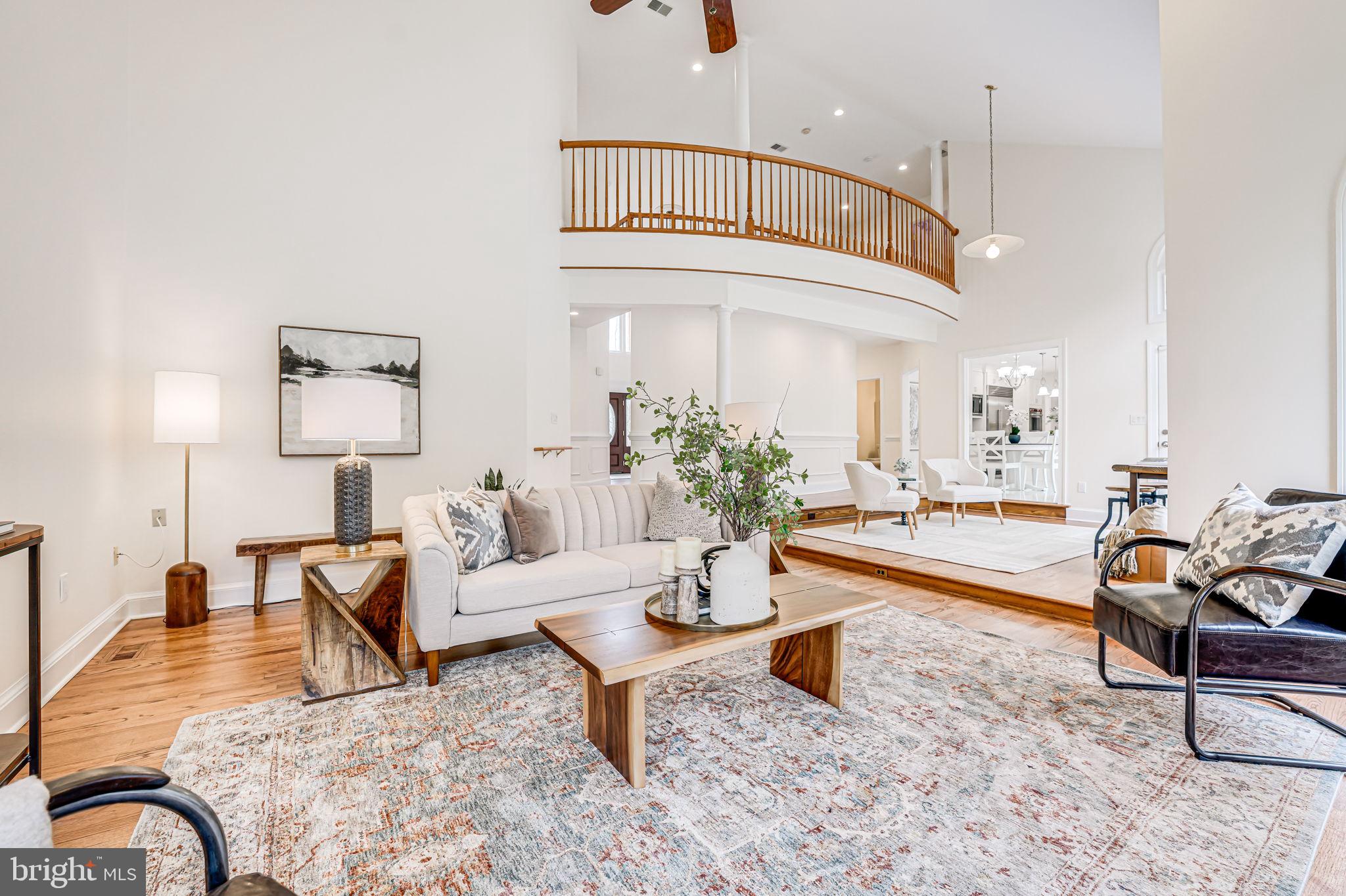 10800 Tradewind Drive Oakton, VA 22124 - Photo 14 of 77 a living room with furniture a rug and a chandelier