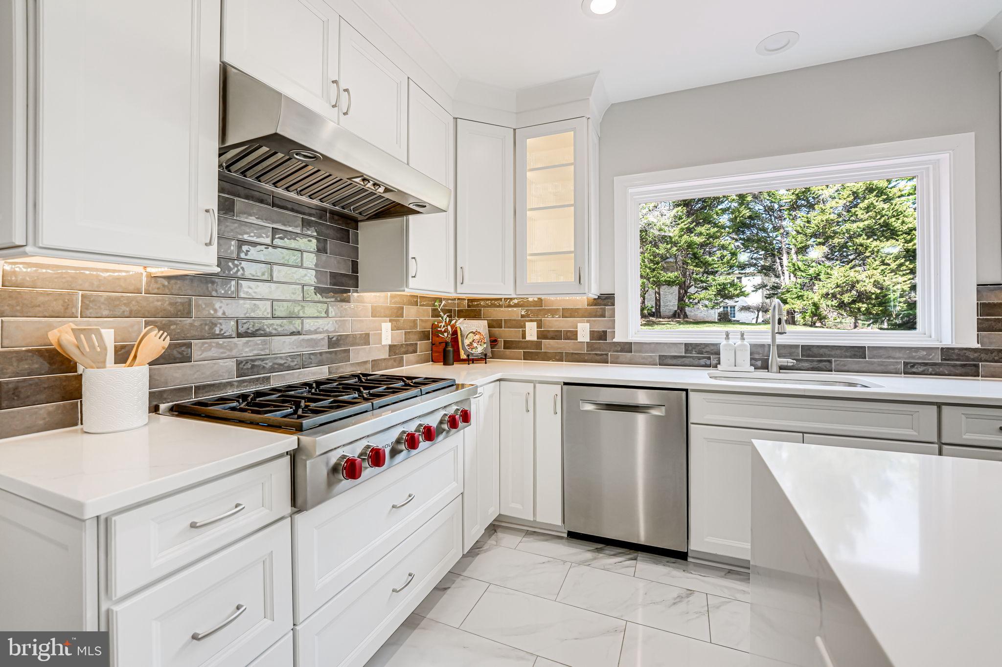 10800 Tradewind Drive Oakton, VA 22124 - Photo 29 of 77 a kitchen with white cabinets and appliances