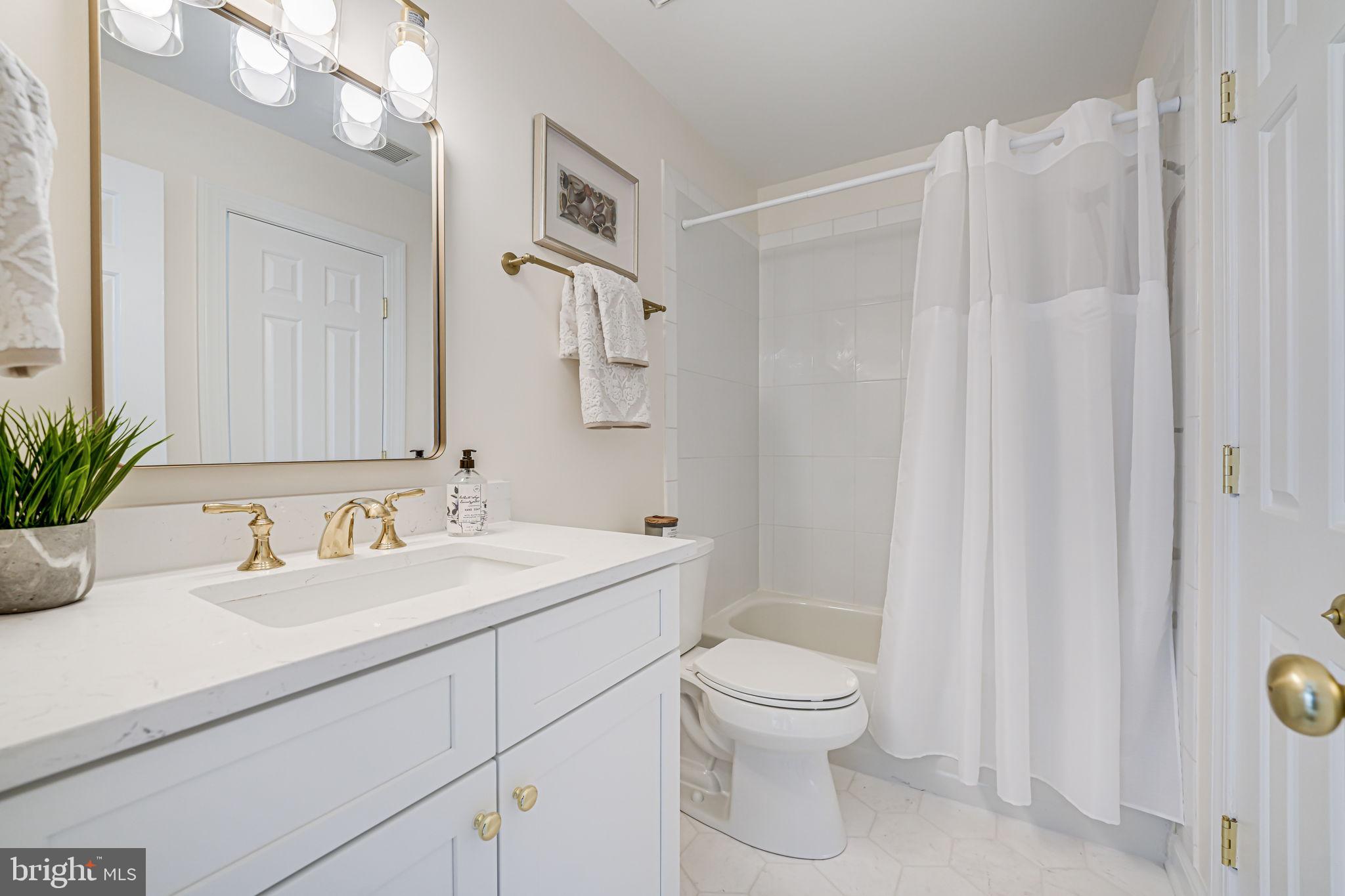 10800 Tradewind Drive Oakton, VA 22124 - Photo 48 of 77 a bathroom with a sink a toilet and a mirror