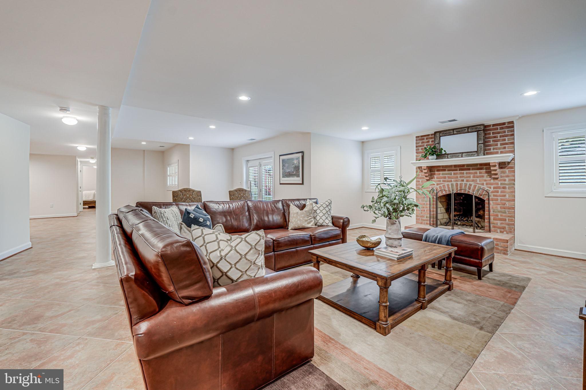10800 Tradewind Drive Oakton, VA 22124 - Photo 53 of 77 a living room with furniture and a fireplace