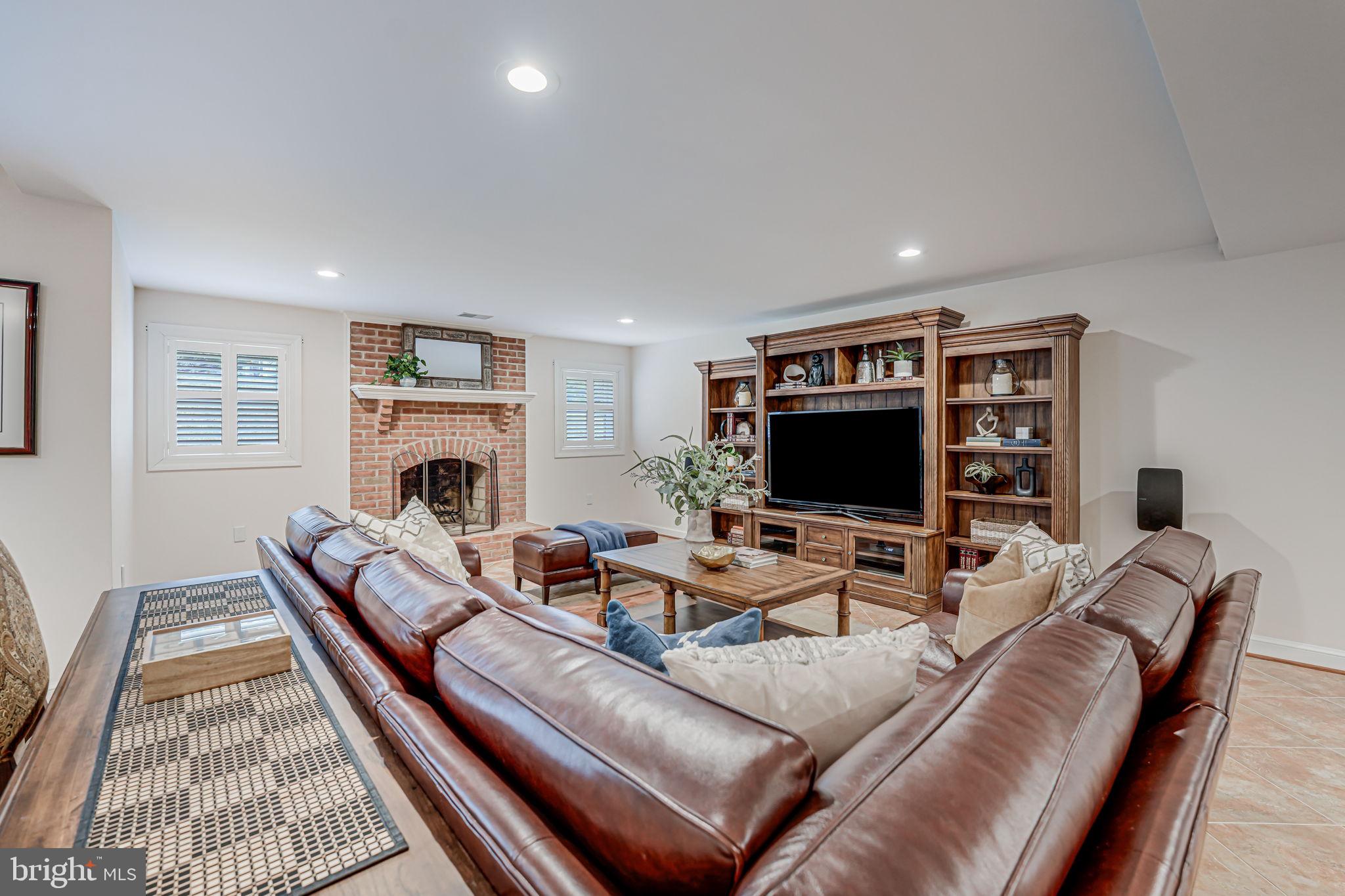 10800 Tradewind Drive Oakton, VA 22124 - Photo 54 of 77 a living room with furniture and a fireplace